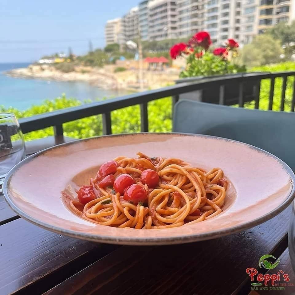 Pasta with cherry tomatoes overlooking the Sliema coast